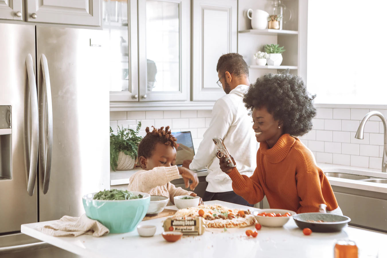 Young parents and child in kitchen